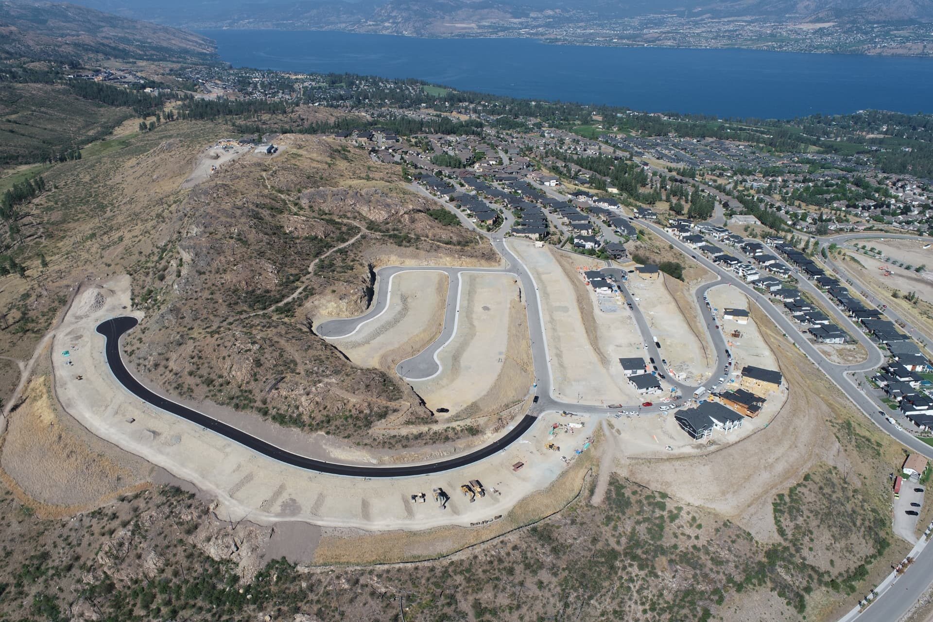 Aerial view of a hillside subdivision mass grading project above Okanagan Lake